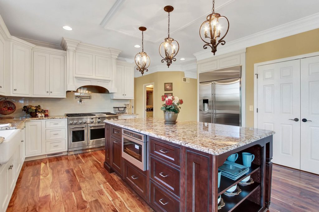 JLH CUSTOM HOME - Kitchen with Custom Cabinetry and oversized island